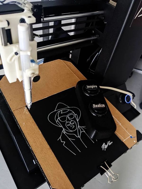 Close-up of the Micasso pen plotter: a converted 3D printer with a pen holder, two arcade buttons, and a freshly drawn portrait on a black card