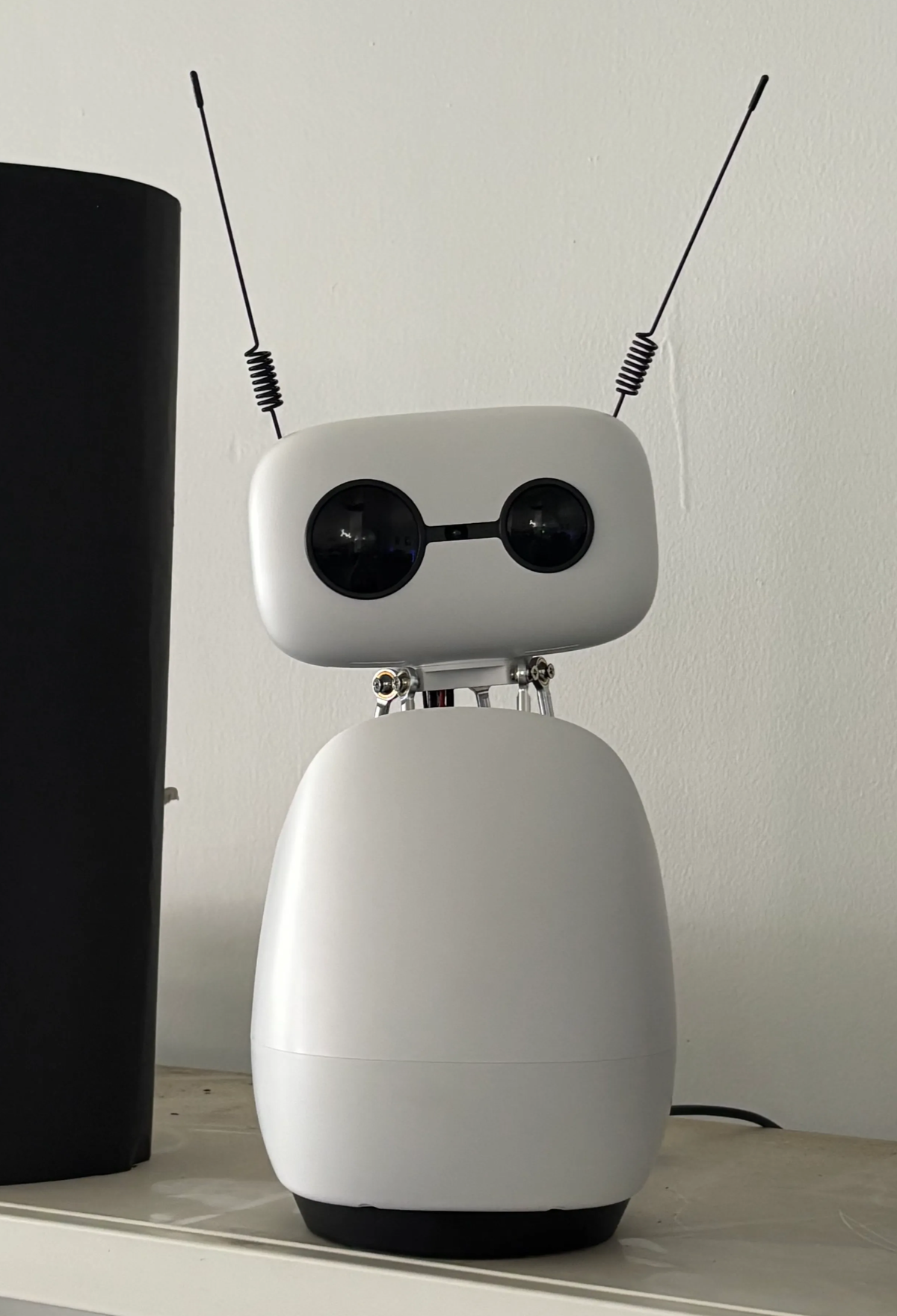 The Reachy Mini robot on the shelf that lights up at every stage of a request: pending, granted, denied.