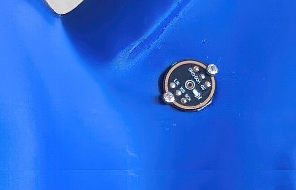 Close-up of a small round microphone PCB set into the side of a blue 3D-printed elephant, with the mic's pin labels (GND, VDD, WS, SCK, L/R) visible around its edge